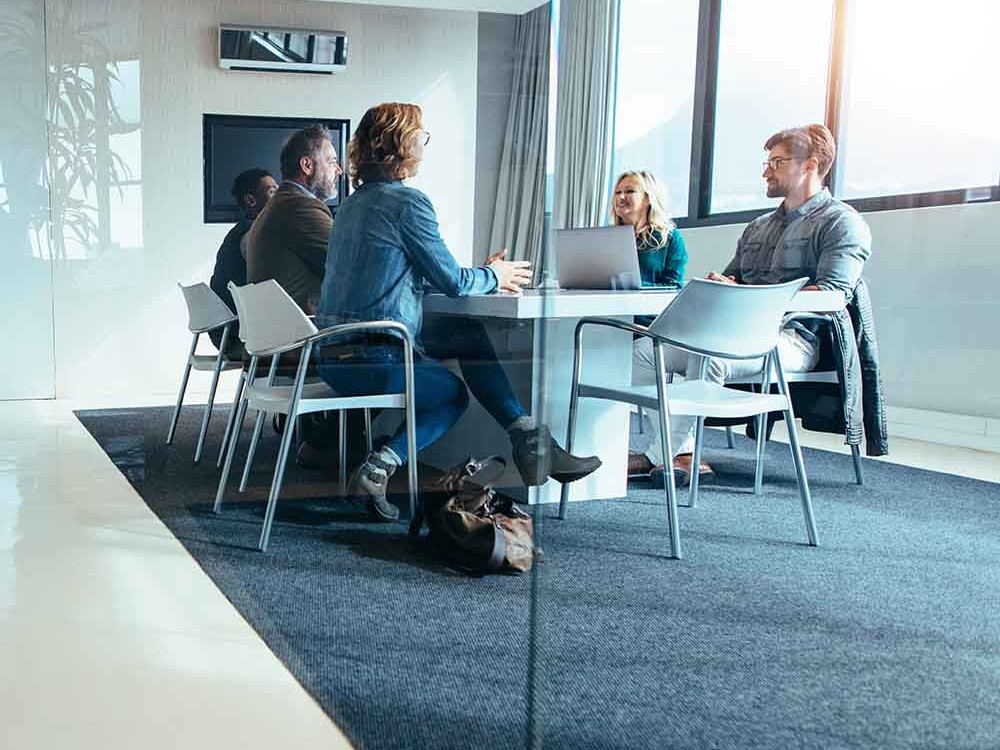five people sitting at a table