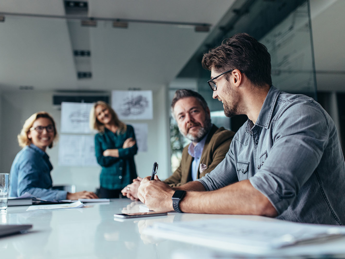 two women and two men working at a conference table